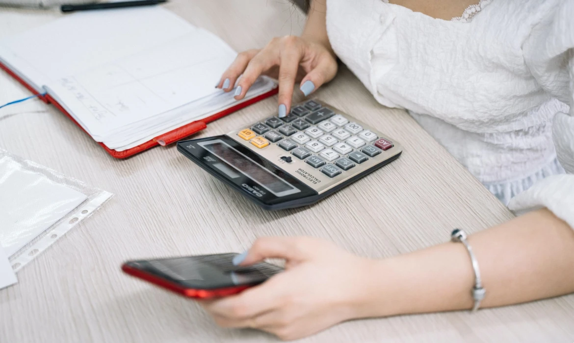 a woman using a calculator and a phone